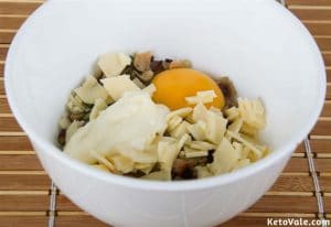 mixing grated cheese with egg