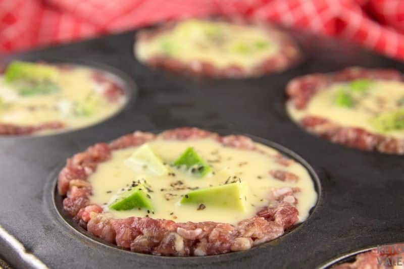 pour egg into avocado muffins