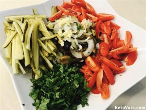 Mixing eggplant salad with tomatoes