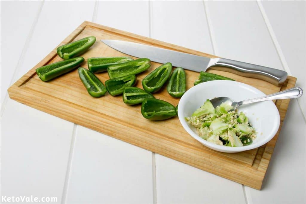 Cut jalapenos in half and remove seeds