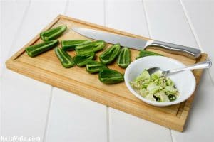 Cut jalapenos in half and remove seeds