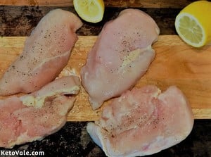 Cut chicken breast then season