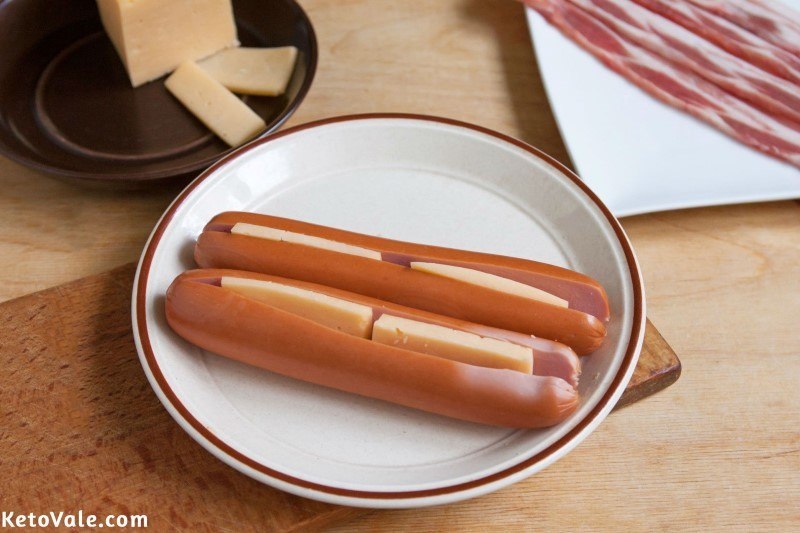 Insert cheese inside hot dogs