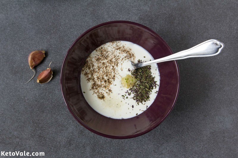 Mix sour cream, garlic, basil, salt and pepper