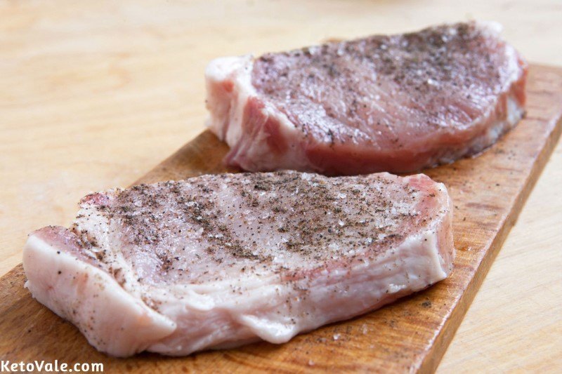 Season pork chops with salt and pepper