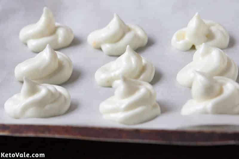 Pipe cookies into baking sheet