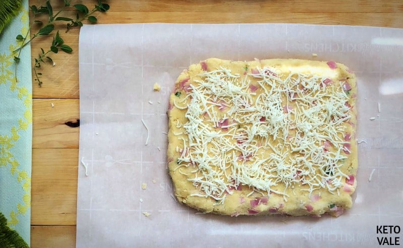 Sprinkle cheese on scone dough