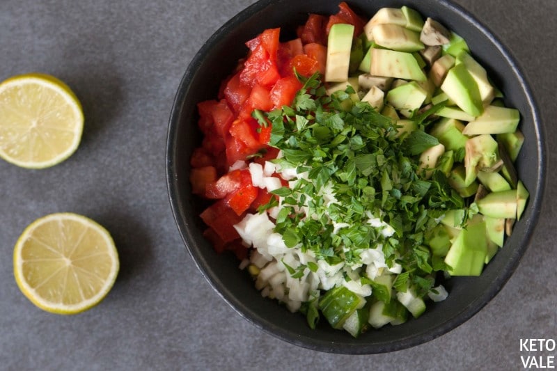 Dice cucumber, tomato and avocado