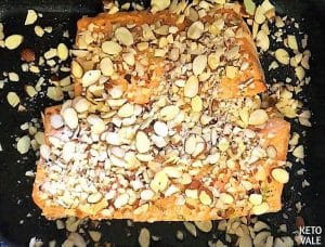 Sprinkle almonds crumbs on Salmon