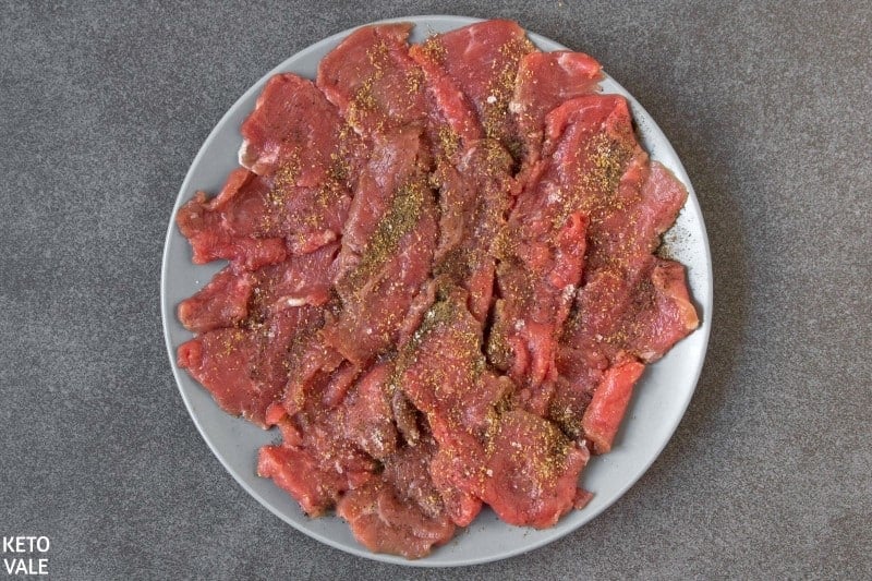 season flat iron steak with salt pepper