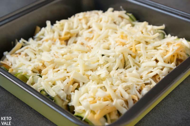 top with cheese and enchilada sauce
