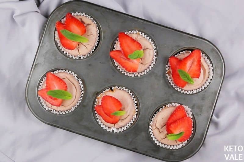 top sliced strawberries on muffins