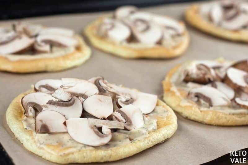 cover pizzas with sauce and mushroom