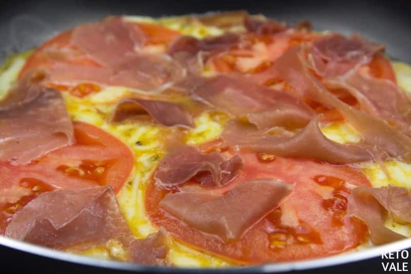 cook eggs add tomato prosciutto